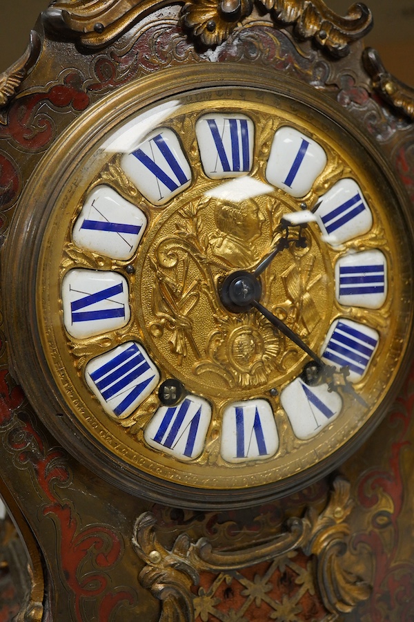 A 19th century Boulle work mantel clock with enamelled Roman numerals, with pendulum and key, 34cm high. Condition - fair, untested